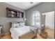 Bright bedroom with gray walls, white bedding, and built in shelves at 2340 W Horsetail Trl, Phoenix, AZ 85085