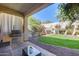 Covered patio with built-in grill and grassy backyard at 2340 W Horsetail Trl, Phoenix, AZ 85085