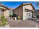 Tan house with a brick walkway, gray door, and desert landscaping at 2340 W Horsetail Trl, Phoenix, AZ 85085