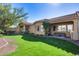 Spacious backyard with covered patio and lush lawn at 2340 W Horsetail Trl, Phoenix, AZ 85085