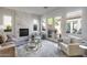 Spacious living room featuring a marble fireplace, large windows, and access to a private patio at 2340 W Horsetail Trl, Phoenix, AZ 85085
