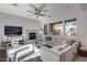 Spacious living room featuring a cozy fireplace and large windows at 2340 W Horsetail Trl, Phoenix, AZ 85085