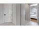 Interior hallway with tile floors, white door, and bedroom view at 2340 W Horsetail Trl, Phoenix, AZ 85085