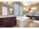 Elegant bathroom with a large soaking tub, double vanity, and separate shower at 2340 W Horsetail Trl, Phoenix, AZ 85085