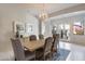 Bright dining room with wooden table and access to backyard at 2340 W Horsetail Trl, Phoenix, AZ 85085