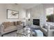 Relaxing living room with a marble fireplace, neutral color palette, and plenty of natural light at 2340 W Horsetail Trl, Phoenix, AZ 85085