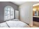 Bedroom with gray walls, white bedding, and large window at 2340 W Horsetail Trl, Phoenix, AZ 85085