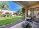 Landscaped backyard with patio, grass area, and access to inside at 2340 W Horsetail Trl, Phoenix, AZ 85085