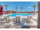 Community pool with lounge chairs and umbrellas at 8865 E Baseline Rd # 504, Mesa, AZ 85209