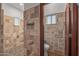 Bathroom with tile shower and flooring, toilet, and single window at 2411 E Caldwell St, Phoenix, AZ 85042