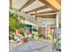 Open living area with high ceilings, exposed beams, and lots of plants at 4549 E Marion Way, Phoenix, AZ 85018