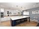 Modern kitchen with island, white cabinets, and quartz countertops at 3413 N 16Th N Dr, Phoenix, AZ 85015