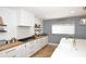 Modern kitchen with white cabinets, butcher block countertops and a farmhouse sink at 3413 N 16Th N Dr, Phoenix, AZ 85015