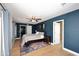 Spacious bedroom with a dark blue accent wall and a queen-sized bed at 3413 N 16Th N Dr, Phoenix, AZ 85015