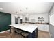 Modern kitchen with white cabinets, quartz countertops and a large island at 3413 N 16Th N Dr, Phoenix, AZ 85015
