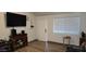 Living room with a large TV and wood-look floors at 2616 N 50Th Ave, Phoenix, AZ 85035