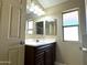 Bathroom with vanity, updated lighting, and large mirror at 414 E 5Th St, Eloy, AZ 85131