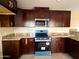Modern kitchen with dark wood cabinets and granite countertops at 414 E 5Th St, Eloy, AZ 85131