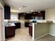Modern kitchen with dark wood cabinets, granite counters, and stainless steel appliances at 414 E 5Th St, Eloy, AZ 85131
