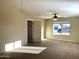 Bright bedroom with carpet, ceiling fan, and large window at 414 E 5Th St, Eloy, AZ 85131