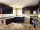 Modern kitchen with dark wood cabinets and granite countertops at 414 E 5Th St, Eloy, AZ 85131