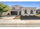 Two-story home with dark brown garage door and white exterior at 19751 W Turney Ave, Litchfield Park, AZ 85340