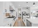 Modern white kitchen with stainless steel appliances and marble countertops at 19751 W Turney Ave, Litchfield Park, AZ 85340