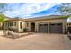 Tan colored house with three-car garage and desert landscaping at 2625 W Via Vis, Phoenix, AZ 85086