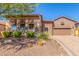 Brick home with landscaped yard, two-car garage, and inviting entryway at 8446 E Laurel St, Mesa, AZ 85207