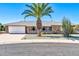 Ranch-style home with brick facade and a large palm tree at 16828 N 108Th Ave, Sun City, AZ 85351