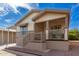 Tan single-wide manufactured home with covered porch and stairs at 9333 E University Dr # 58, Mesa, AZ 85207