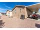 Back of tan single-wide manufactured home with gravel landscaping at 9333 E University Dr # 58, Mesa, AZ 85207