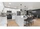 Open concept kitchen with white cabinets, large island, and stainless steel appliances at 454 E Hackamore St, Mesa, AZ 85203