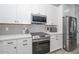 Modern kitchen with stainless steel appliances and white cabinets at 22706 N 184Th Ave, Surprise, AZ 85387