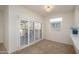 Bright bonus room with sliding door to patio and window shutters at 18320 N Las Rocas Way, Surprise, AZ 85374