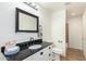 Updated bathroom with single vanity and black countertop at 5160 E Karen Dr, Scottsdale, AZ 85254