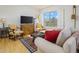 Bright living room with hardwood floors and comfy seating at 2201 N Central Ave # 4E, Phoenix, AZ 85004