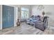 Living room with leather reclining furniture and wood-look floors at 8708 S 50Th Ln, Laveen, AZ 85339