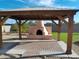 Covered patio area with a brick fireplace and a pergola at 7221 W Angela Dr, Glendale, AZ 85308