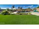 Artificial turf lawn with a modern pool and water feature at 2308 E Dry Wood Rd, Phoenix, AZ 85024