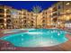 Community pool at night with building view at 5450 E Deer Valley Dr # 1209, Phoenix, AZ 85054
