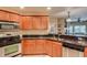 Modern kitchen with wood cabinets, granite counters, and stainless appliances at 5450 E Deer Valley Dr # 1209, Phoenix, AZ 85054