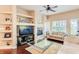 Living room with fireplace, built-in shelving, and hardwood floors at 5450 E Deer Valley Dr # 1209, Phoenix, AZ 85054