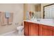 Bathroom with wood vanity and white tile flooring at 5450 E Deer Valley Dr # 1209, Phoenix, AZ 85054