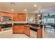 Modern kitchen with wood cabinets, granite counters, and stainless appliances at 5450 E Deer Valley Dr # 1209, Phoenix, AZ 85054