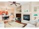 Living room with fireplace, built-in shelving and hardwood floors at 5450 E Deer Valley Dr # 1209, Phoenix, AZ 85054