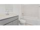 Clean bathroom with gray vanity, bathtub, and marble shower surround at 7400 E White Tail Rd, San Tan Valley, AZ 85143