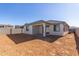 Rear view of house showcasing a covered patio and desert landscaping at 7400 E White Tail Rd, San Tan Valley, AZ 85143