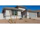 New construction home with gray garage door and small front yard at 7400 E White Tail Rd, San Tan Valley, AZ 85143