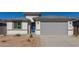 Newly constructed home with gray garage door and desert landscaping at 7400 E White Tail Rd, San Tan Valley, AZ 85143